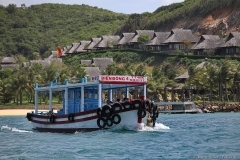 Вьетнам. Прогулочное судно на фоне домиков пятизведочного отеля на острове.  Фотограф Дмитрий Фуфаев. Фотосъемка по всему миру